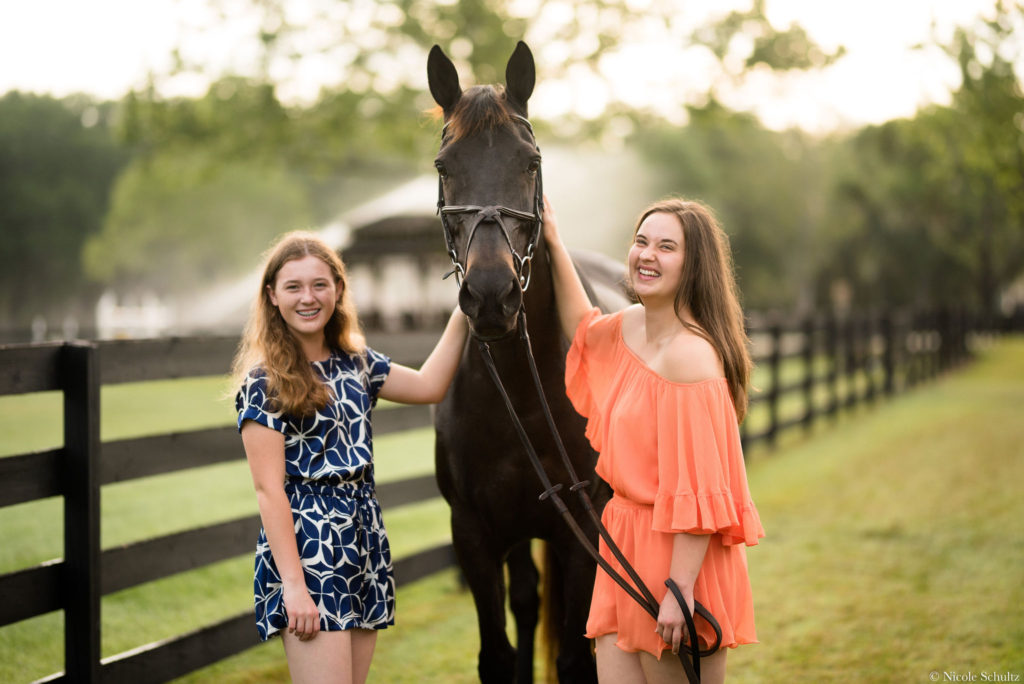 Brunette-Girl-Wearing-Orange-Romper-and-Blue-And-White-Pattern-Romper-With-Brown-Warmblood-Mare-Horse