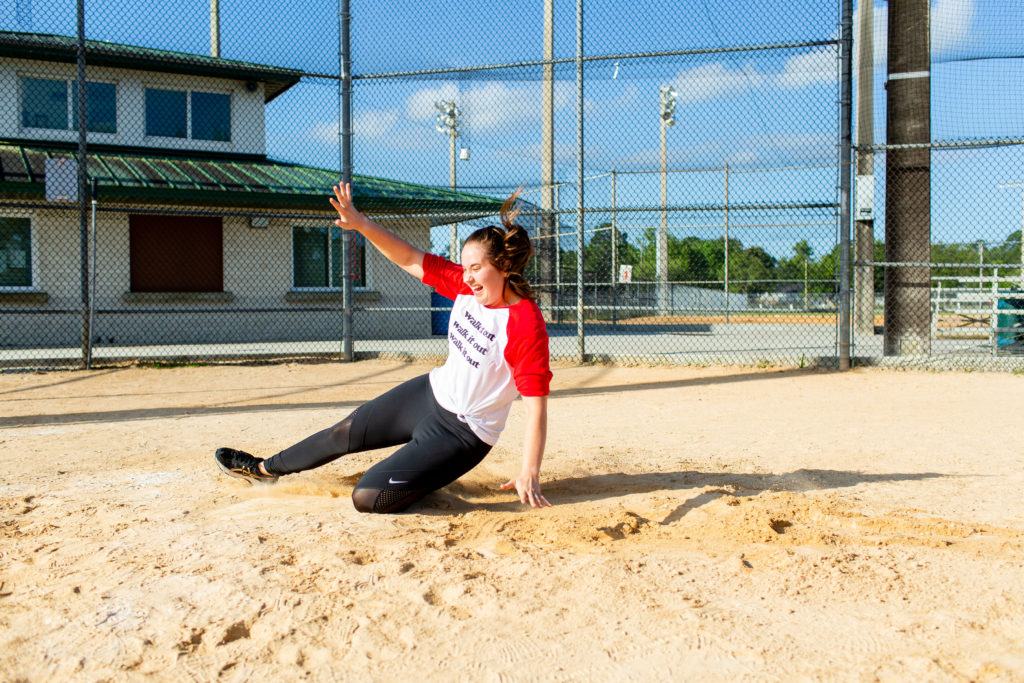 Brunette-Girl-Wearing-Charlie-Southern-Walk-It-Out-Tee-And-Nike-Workout-Leggings-Sliding-Into-Home-Plate-At-Baseball-Field