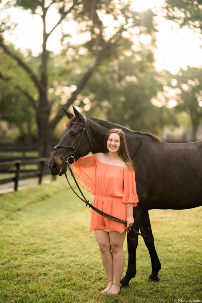 7-ways-to-keep-your-horse-cool-this-summer-Brunette-Girl-Wearing-Orange-Romper-With-Brown-Warmblood-Mare