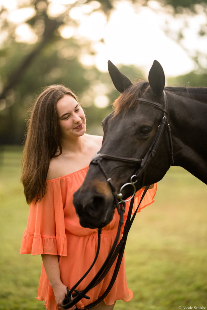 7-ways-to-keep-your-horse-cool-this-summer-Brunette-Girl-Wearing-Orange-Romper-With-Brown-Warmblood-Mare