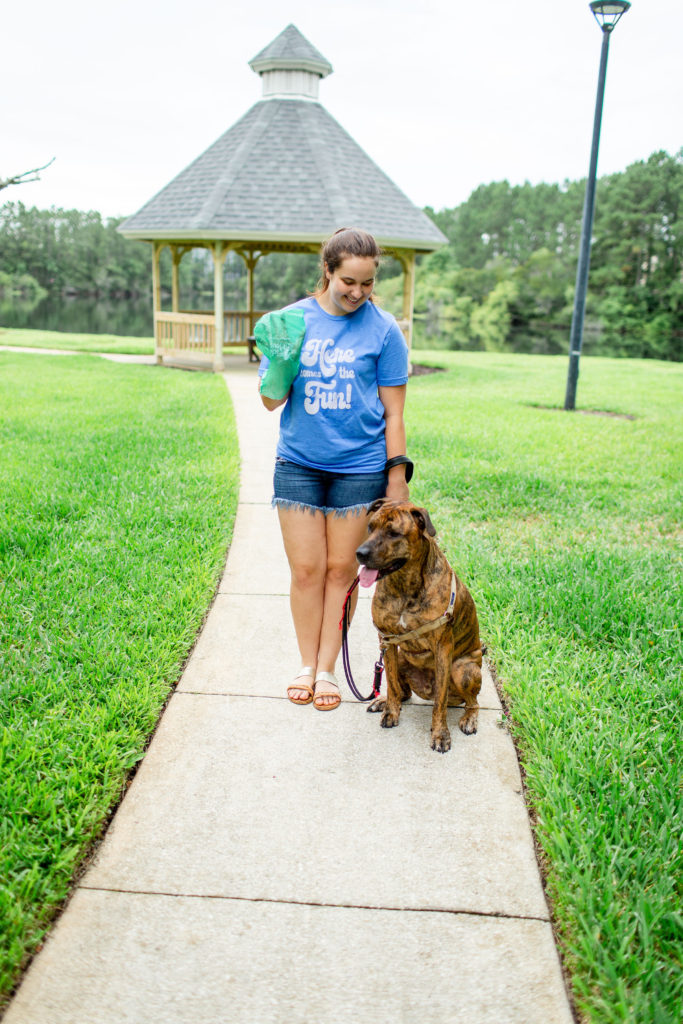 Girl-With-Brindle-Dog-Talking-About-Why-You-Should-Clean-Up-After-Your-Dog